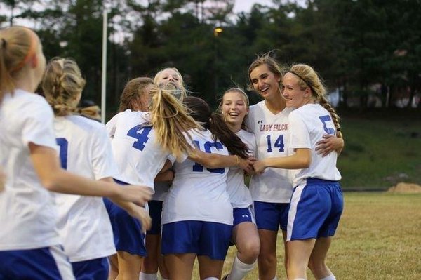 Girl's soccer team celebrating a victory