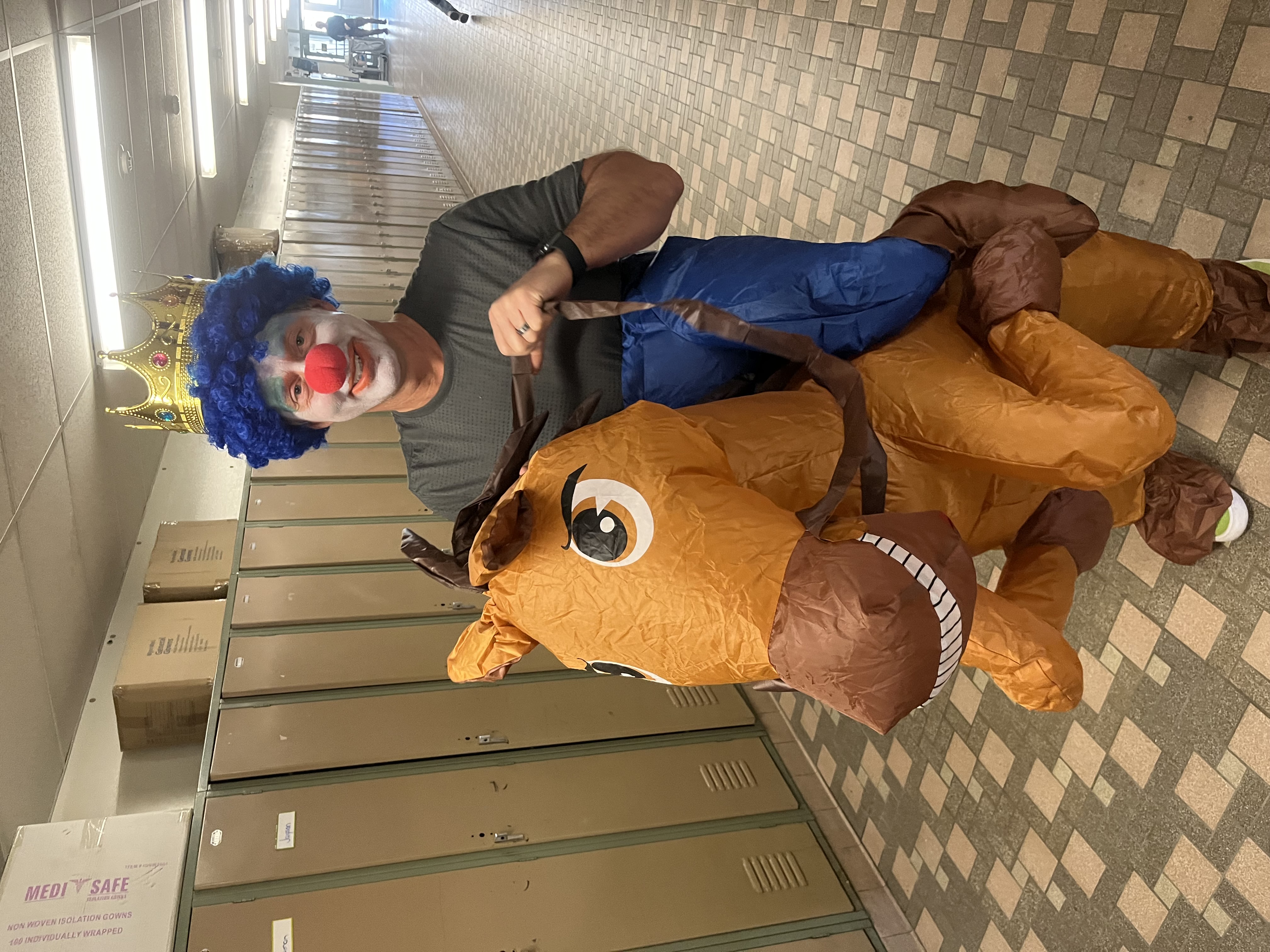 Mr. D dressed wearing clown makeup, a crown, and a horse costume!