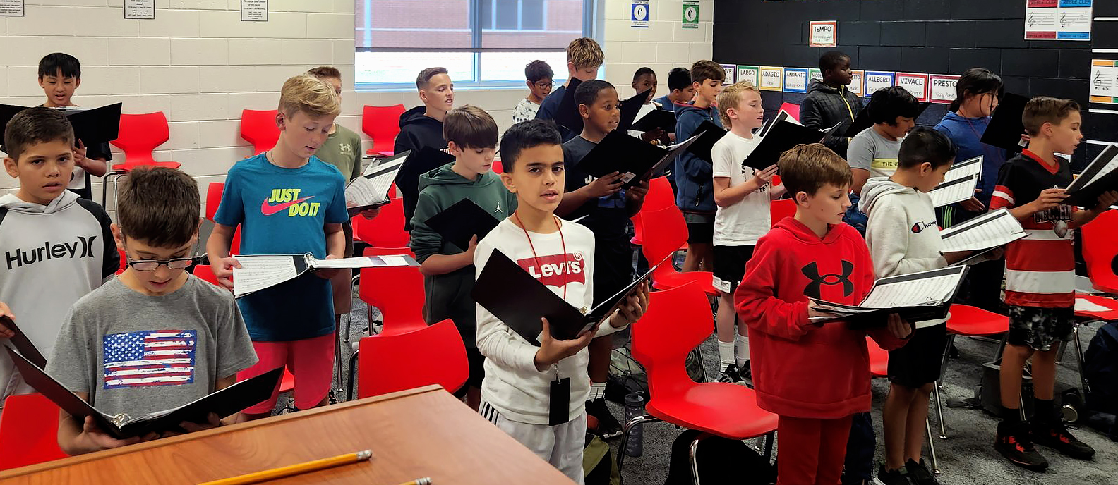 sixth grade choir students rehearse in class