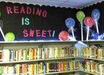 books and sign saying reading is sweet