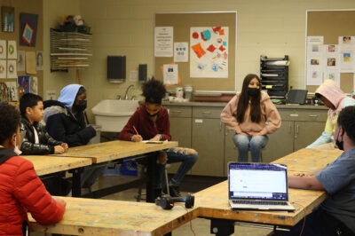 Students sitting around conference table