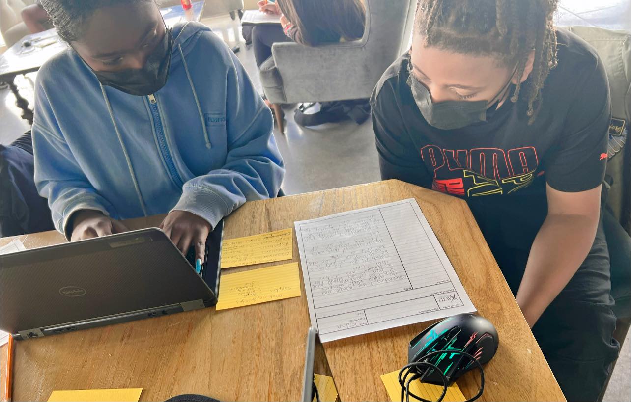 Saniyah and Jordan are working on a science project that involves building a bridge. They are using the scientific method to document their progress. (Science Time is Good Time at UpGrade Media Arts School)