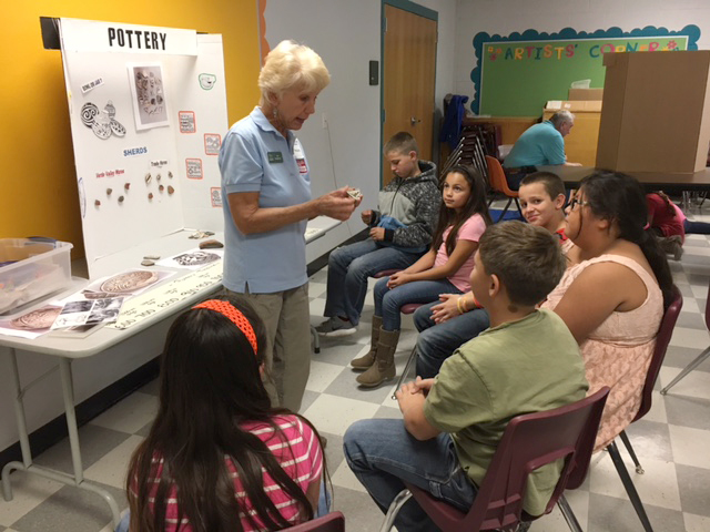 image of a teacher demonstrating something to students