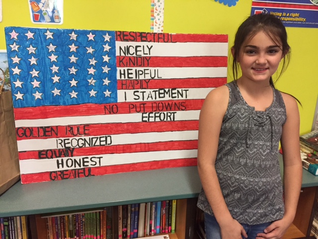 student next to a hand colored american flag