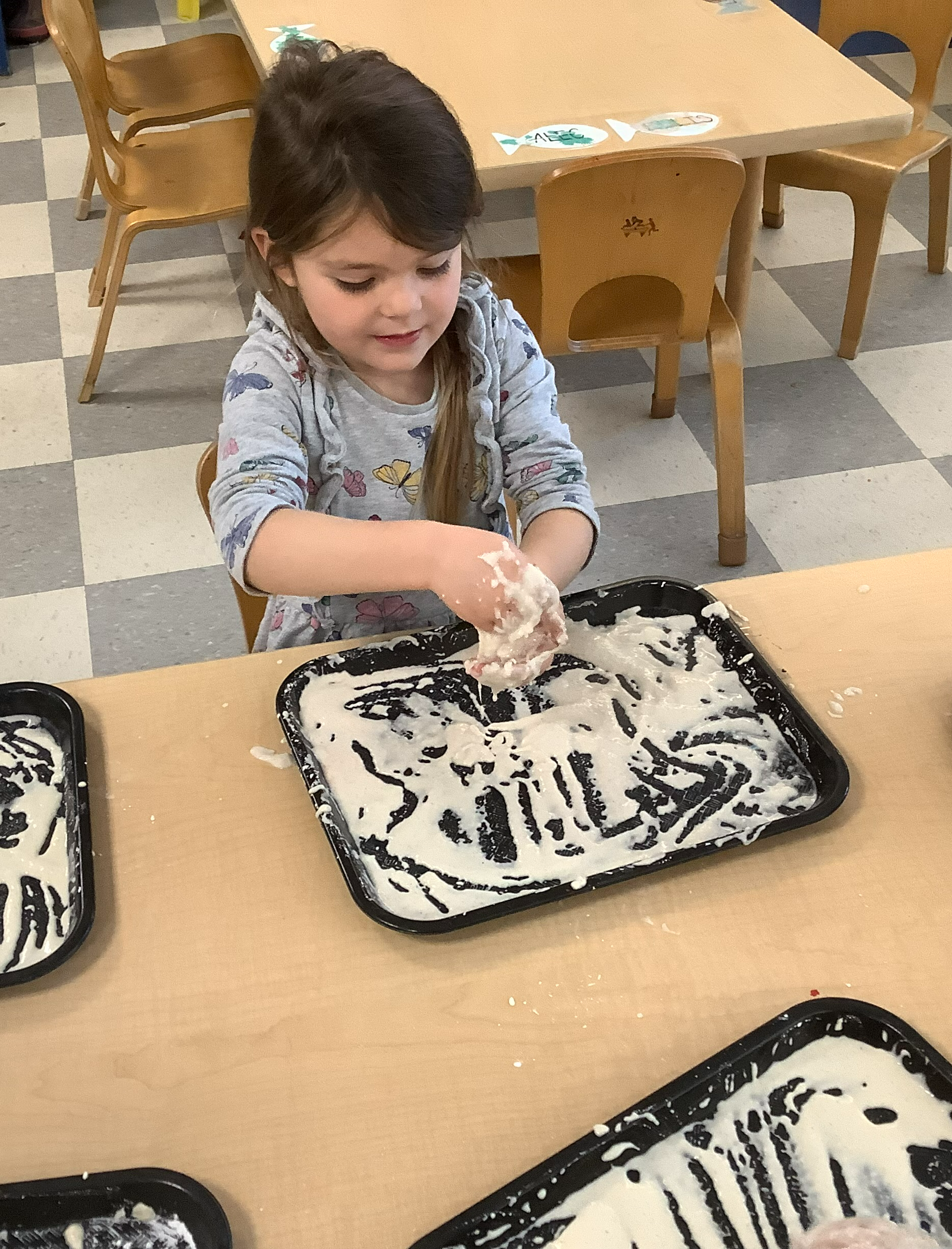 child playing with liquid clay