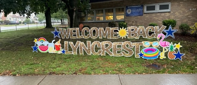 Welcome Back Lyncrest Sign with flamingo and other summery items