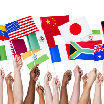Flags of different cultures with hands raised holding them 