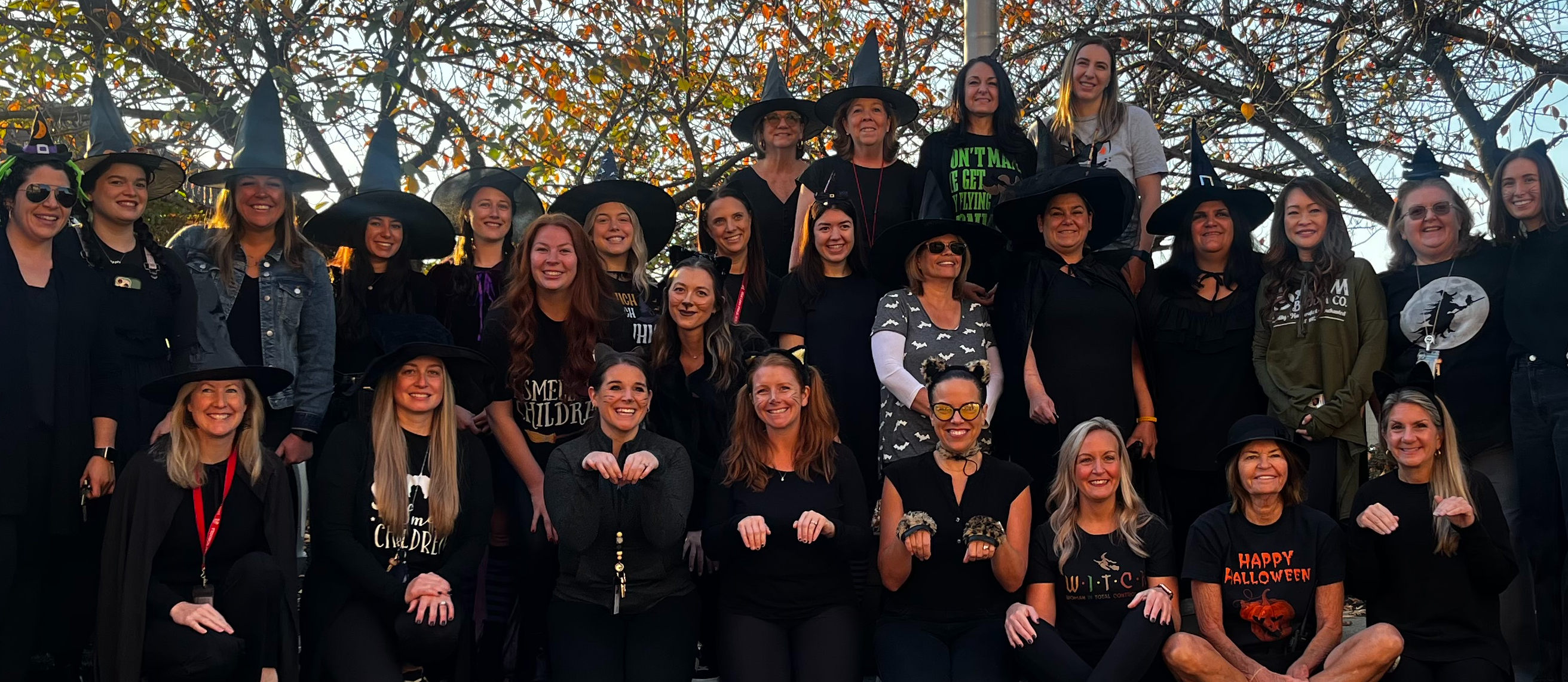 teachers dressed as witches and black cats for halloween