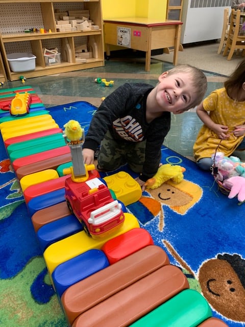 Preschool student playing with toys