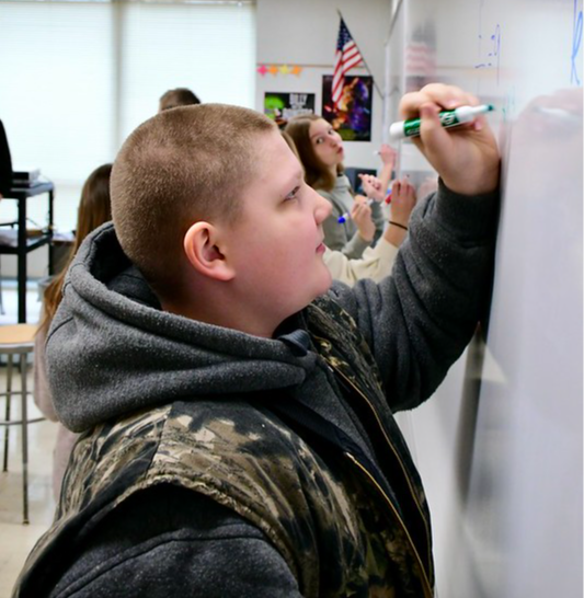 Student working at the white board