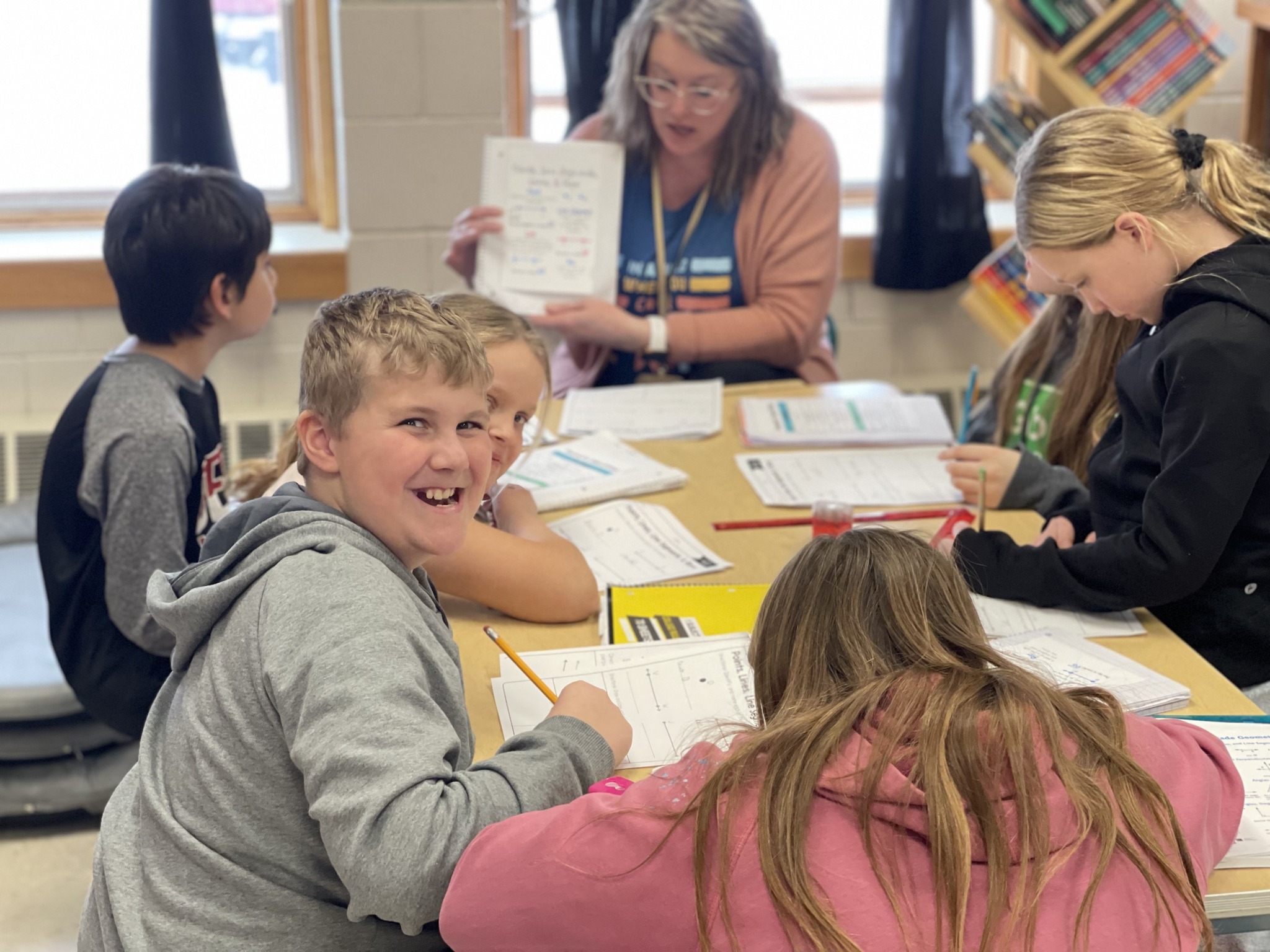 Students smiling while working on a group project