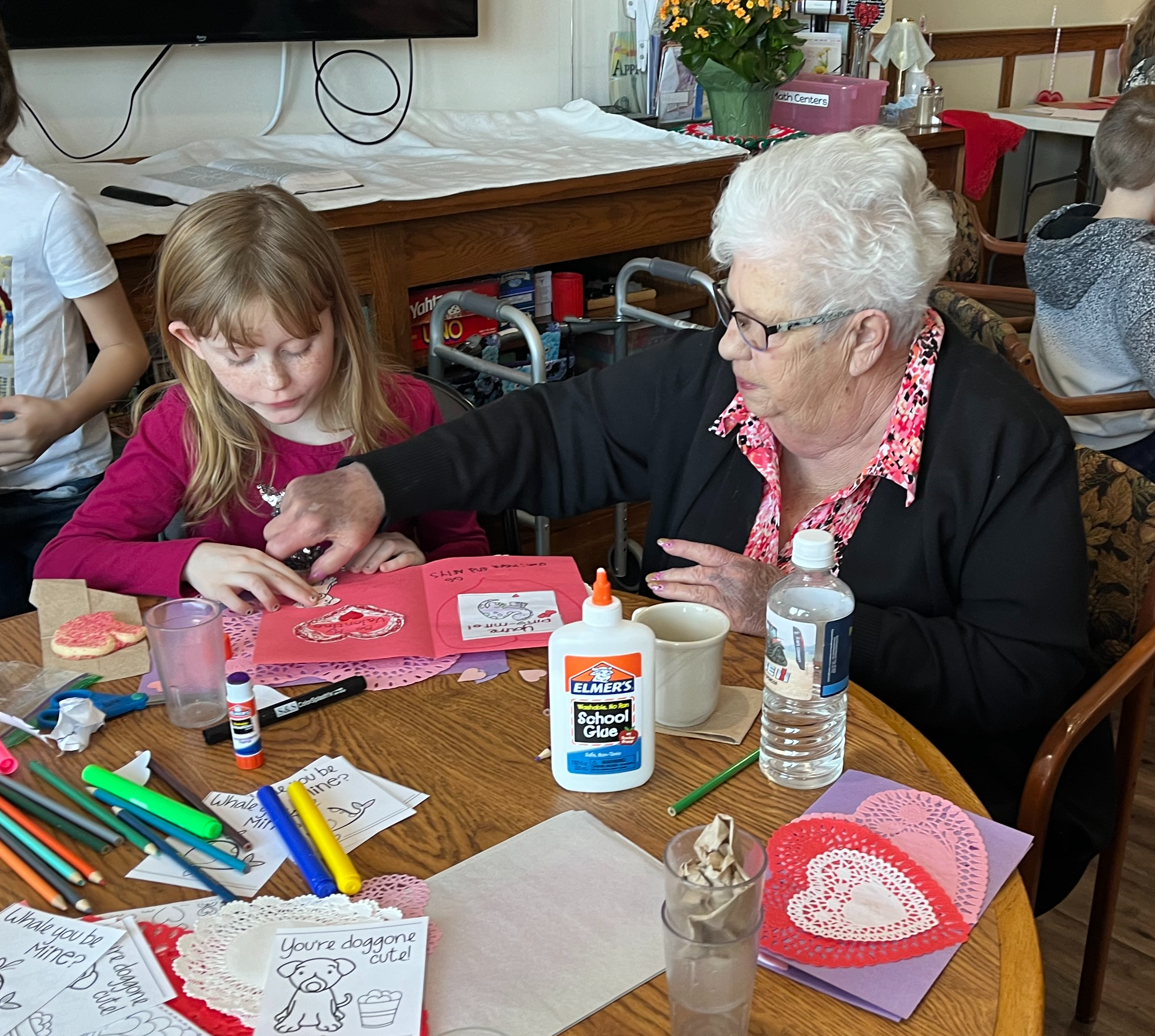 Student and community members making valentines cards