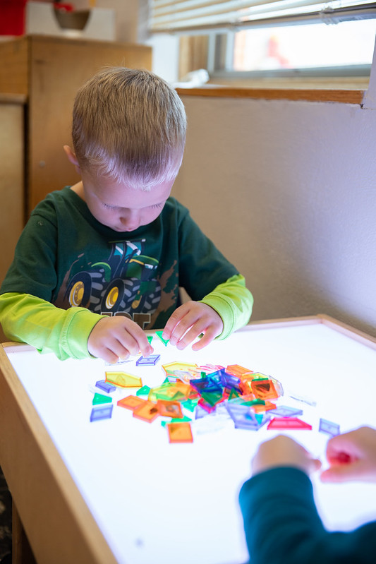 Student playing at light table