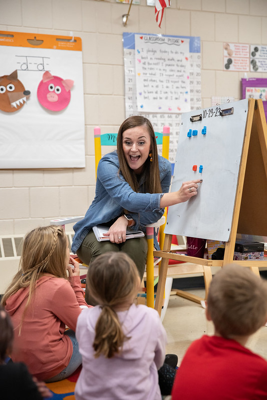 Teacher writing on an easel