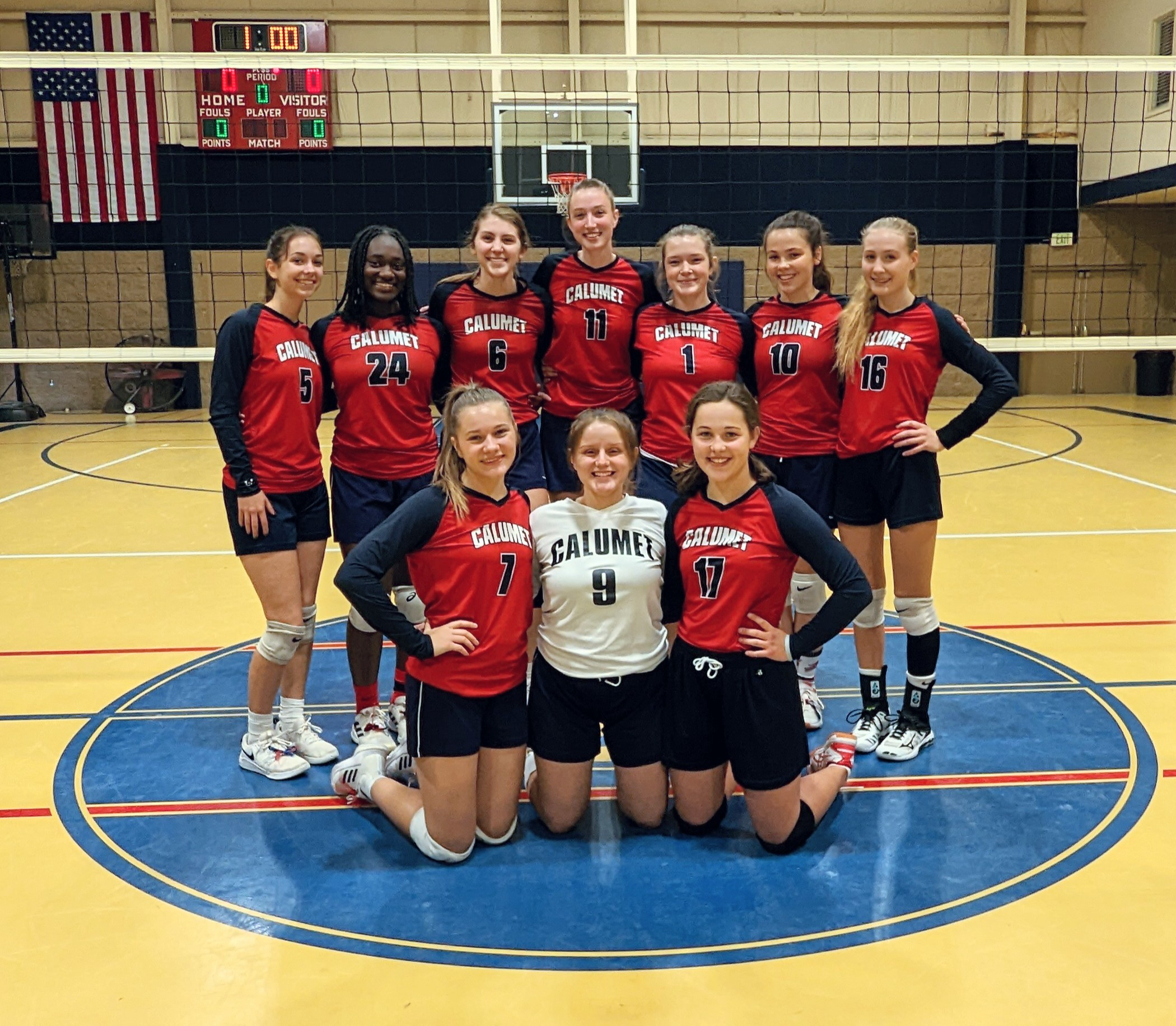 female volleyball players posing for a team photo