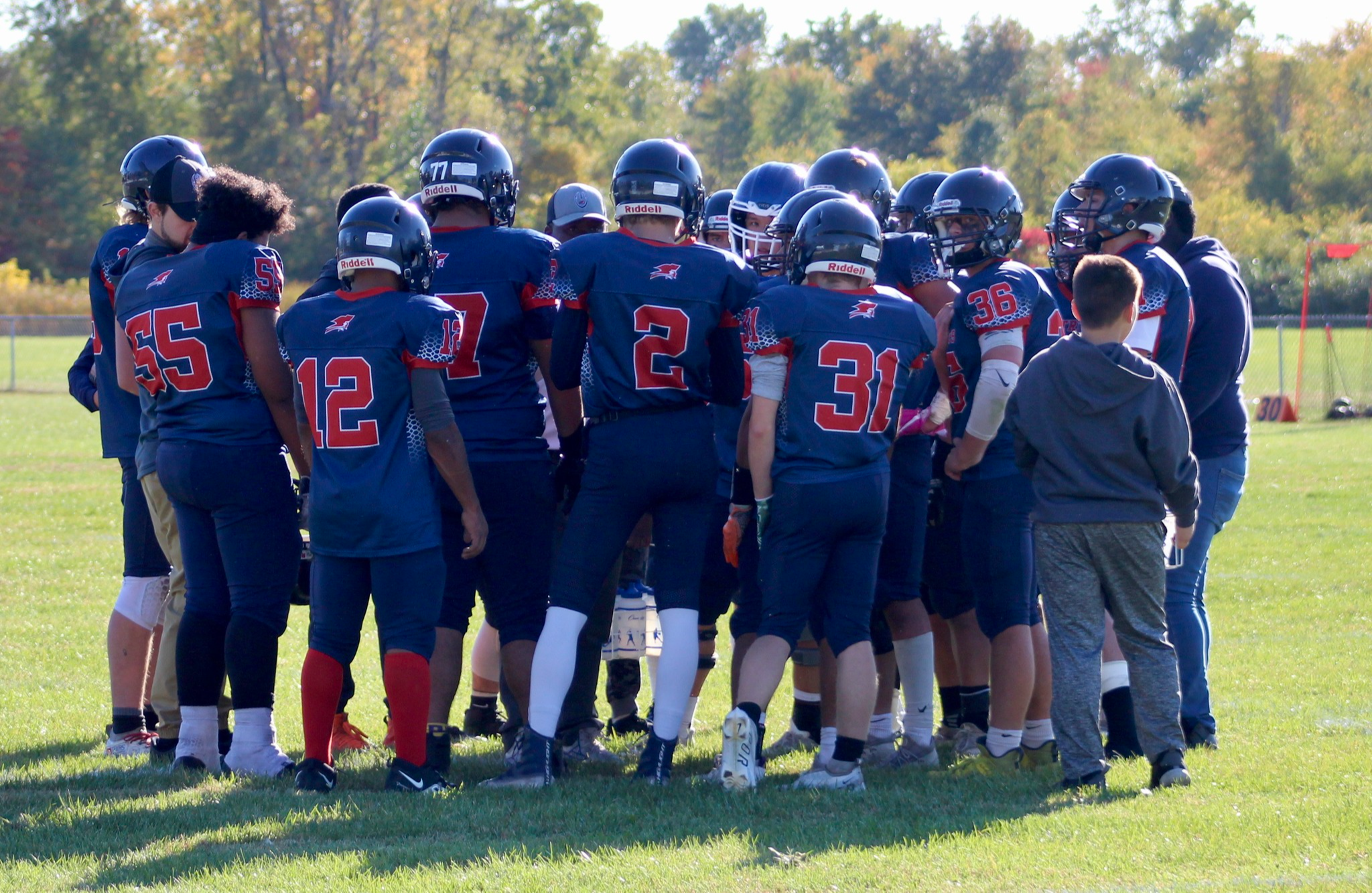 football players huddled up for a team chant