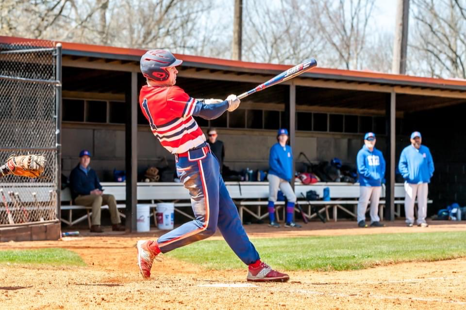 baseball player swinging at bat