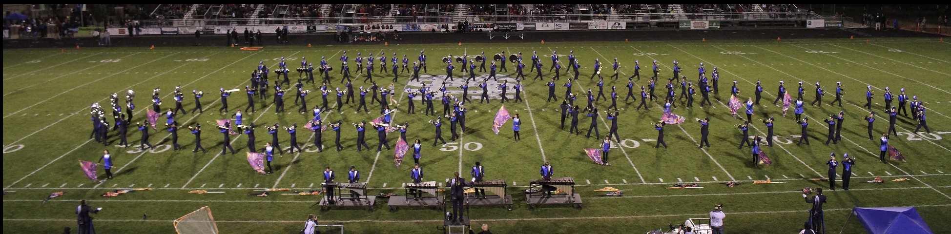 photo of the football yard with the band members in a routine