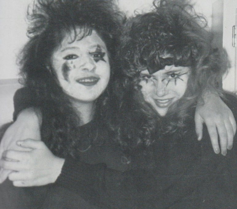 2 students with crazy makeup and big hair
