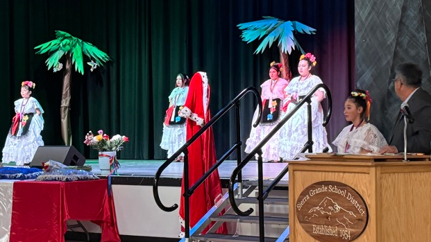 Students and presenter at a Cinco de Mayo event in a gym