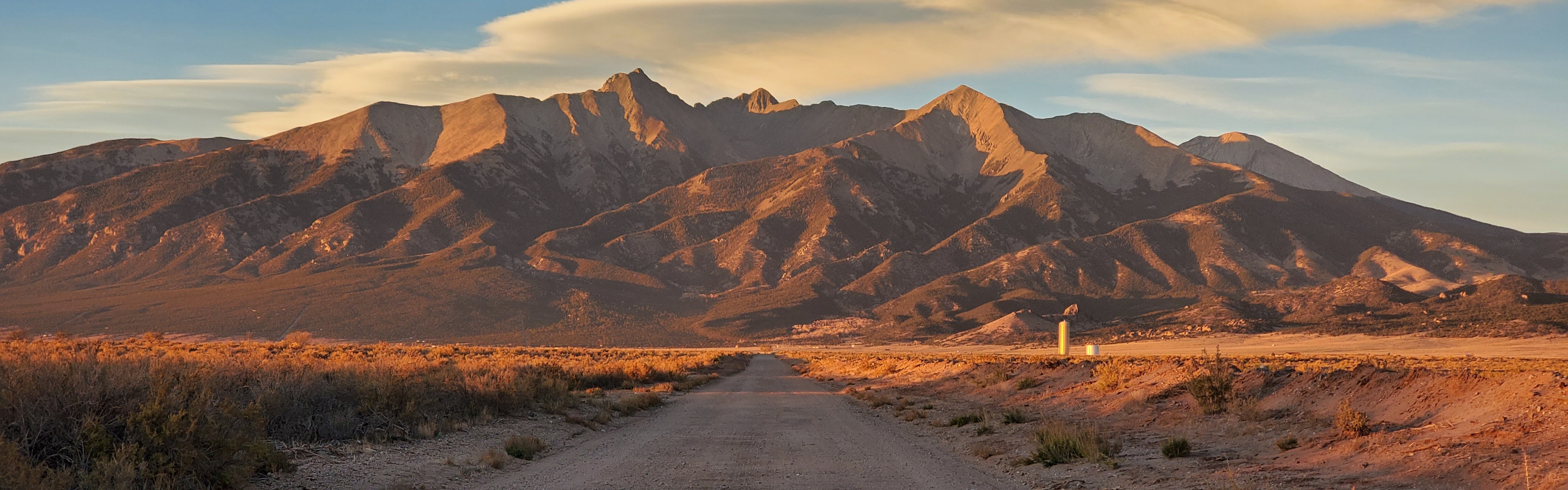 Photograph of a mountain range with a sunset hue.