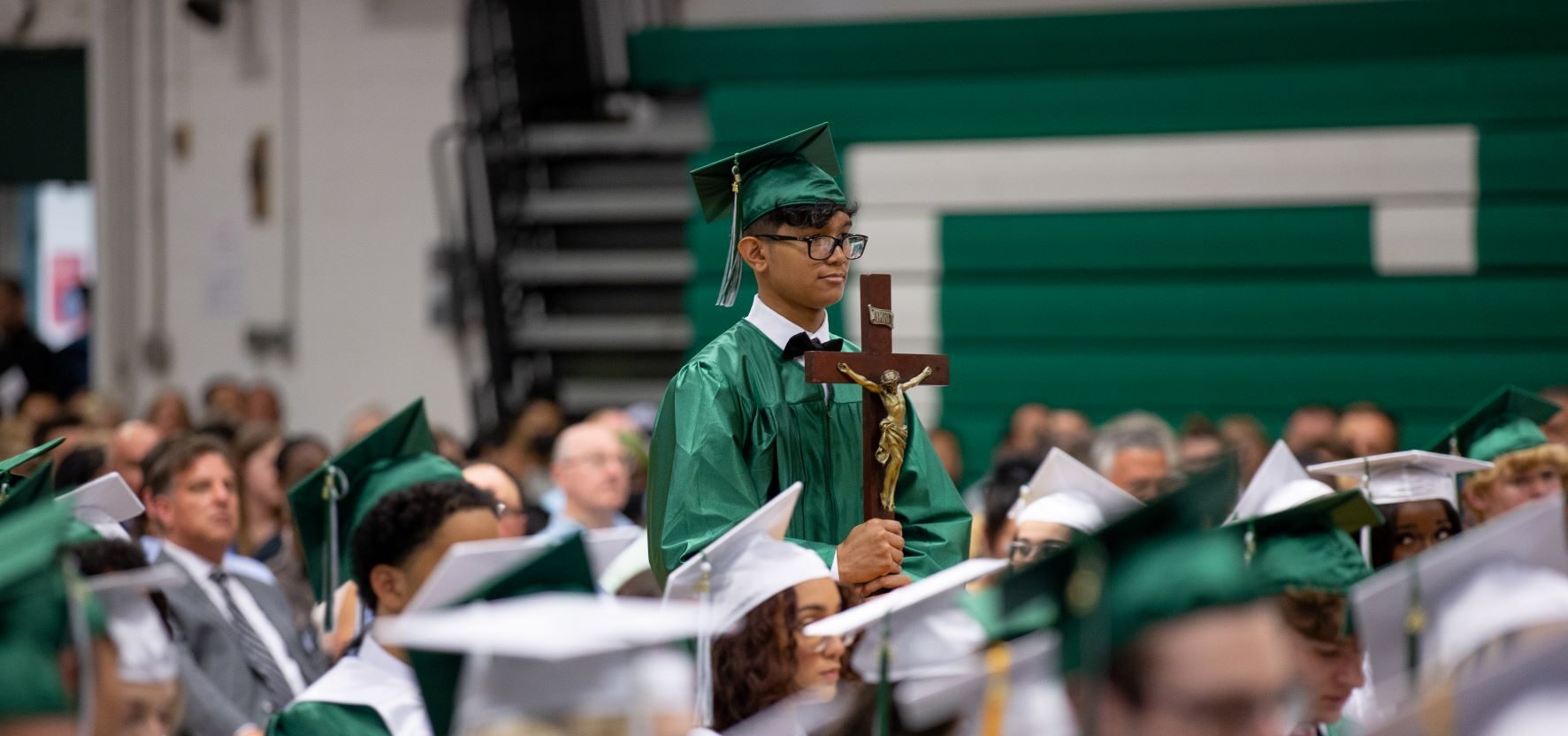 student holding cross