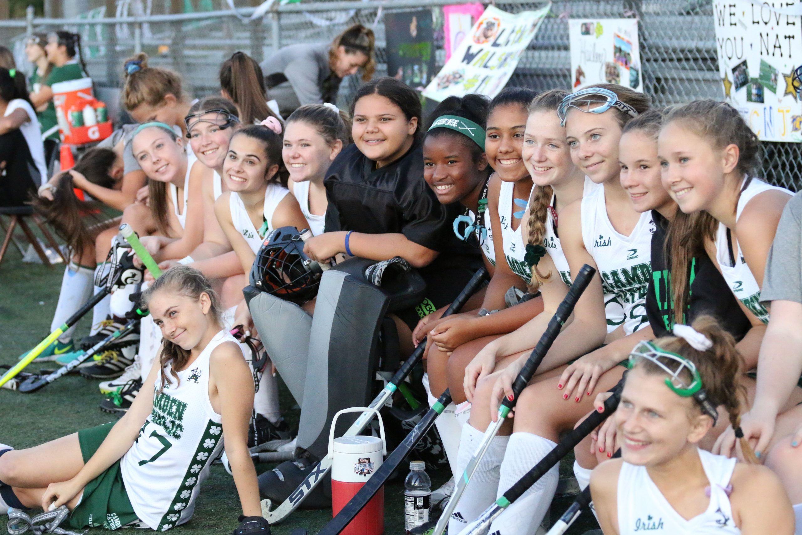 students taking group picture at match of field hockey