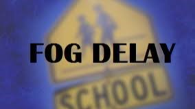 Yellow School Crossing Sign blue sky background test says fog delay