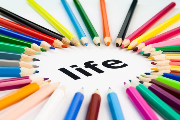 colored pencils in a circle around the word life written in black