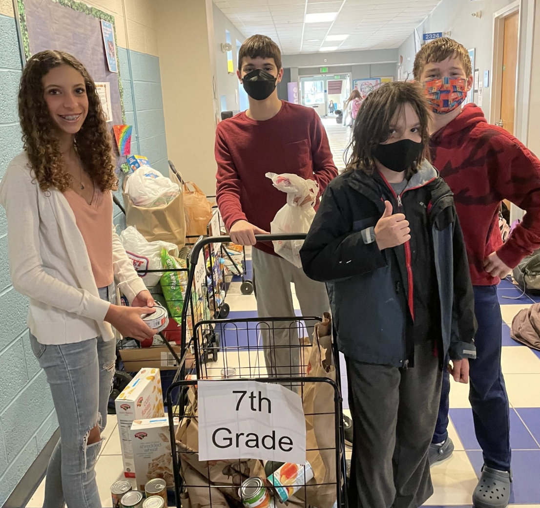 YMS grades collected goods for the local food band. 