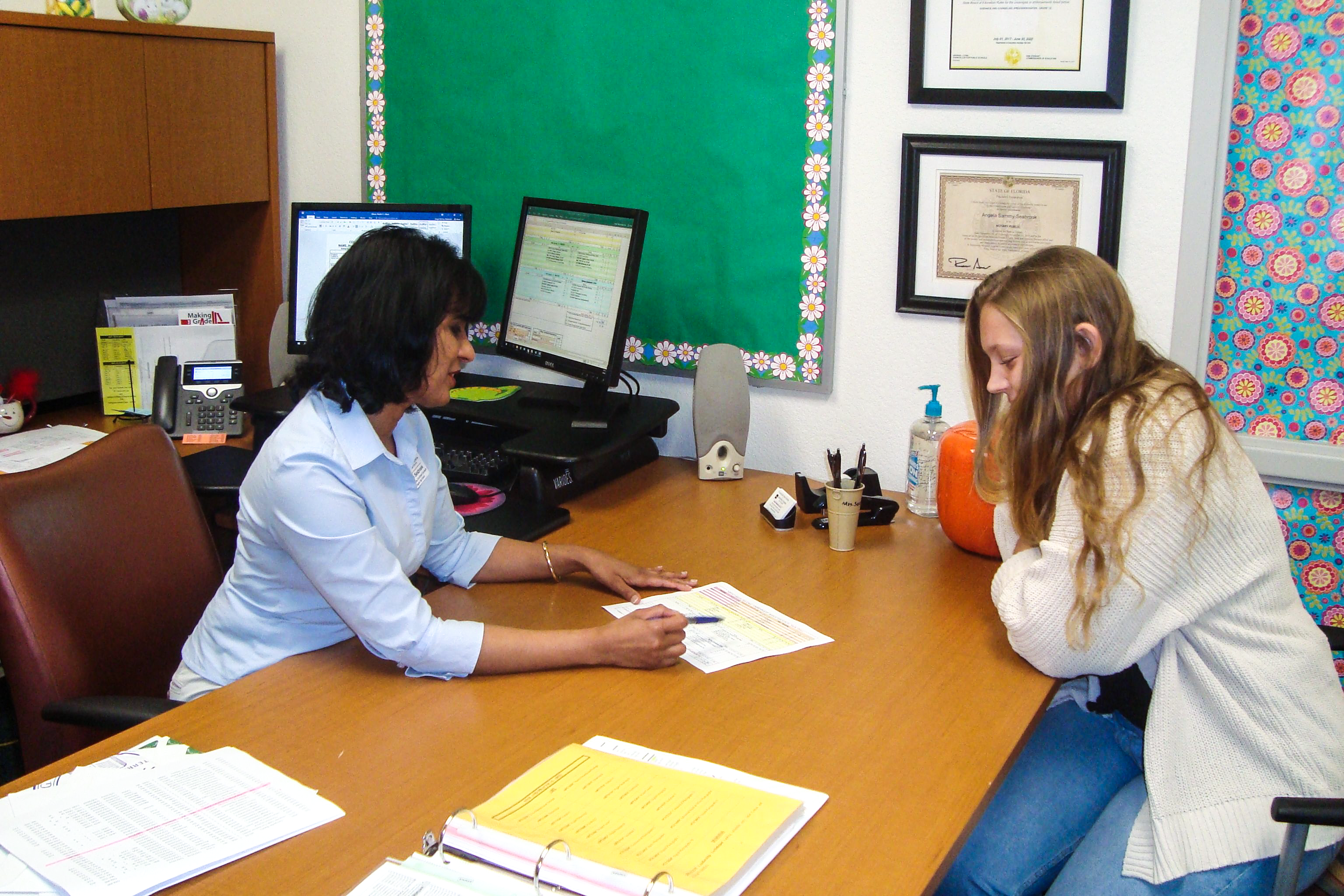 Counselor and Student chatting at an office