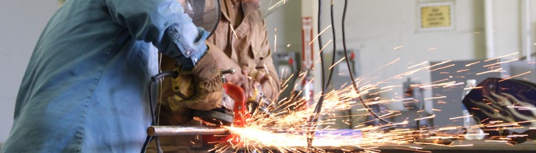 students welding, sparks