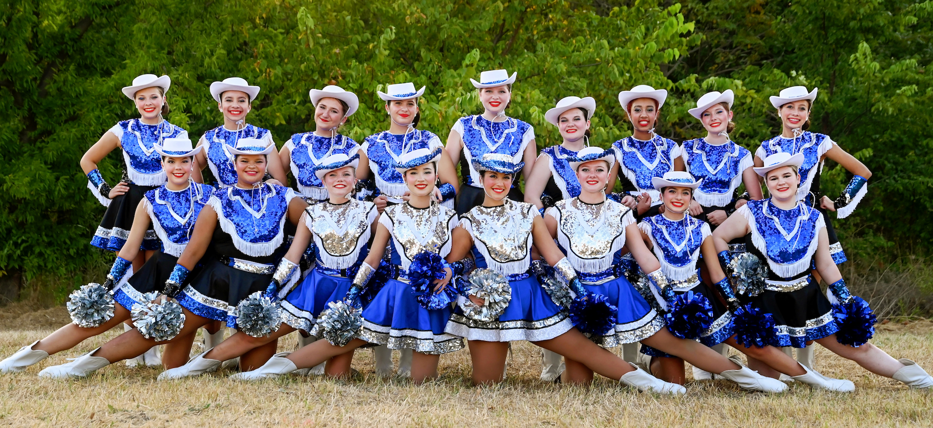 dolls in stands with poms