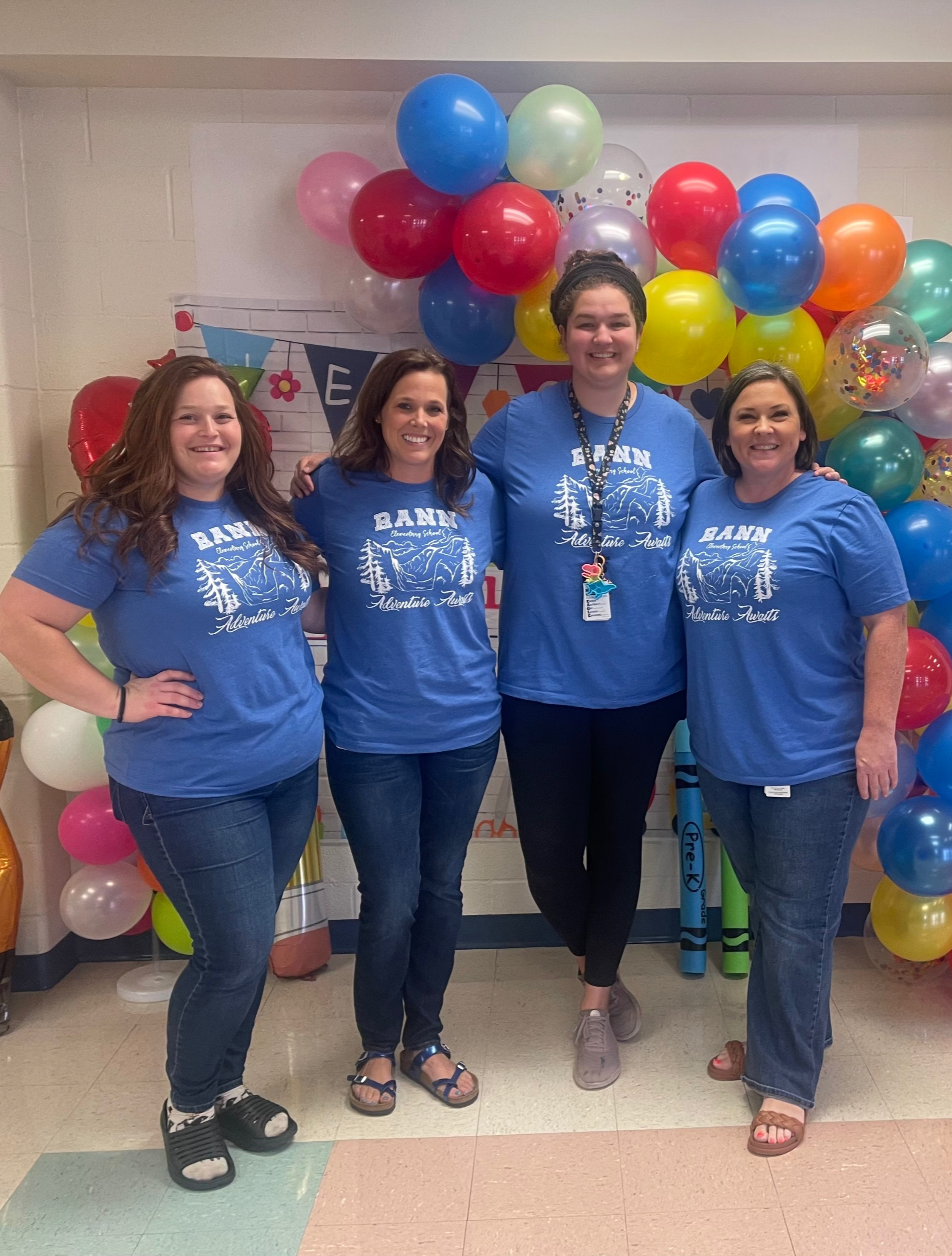 rotation teachers in blue shirts in front of balloons