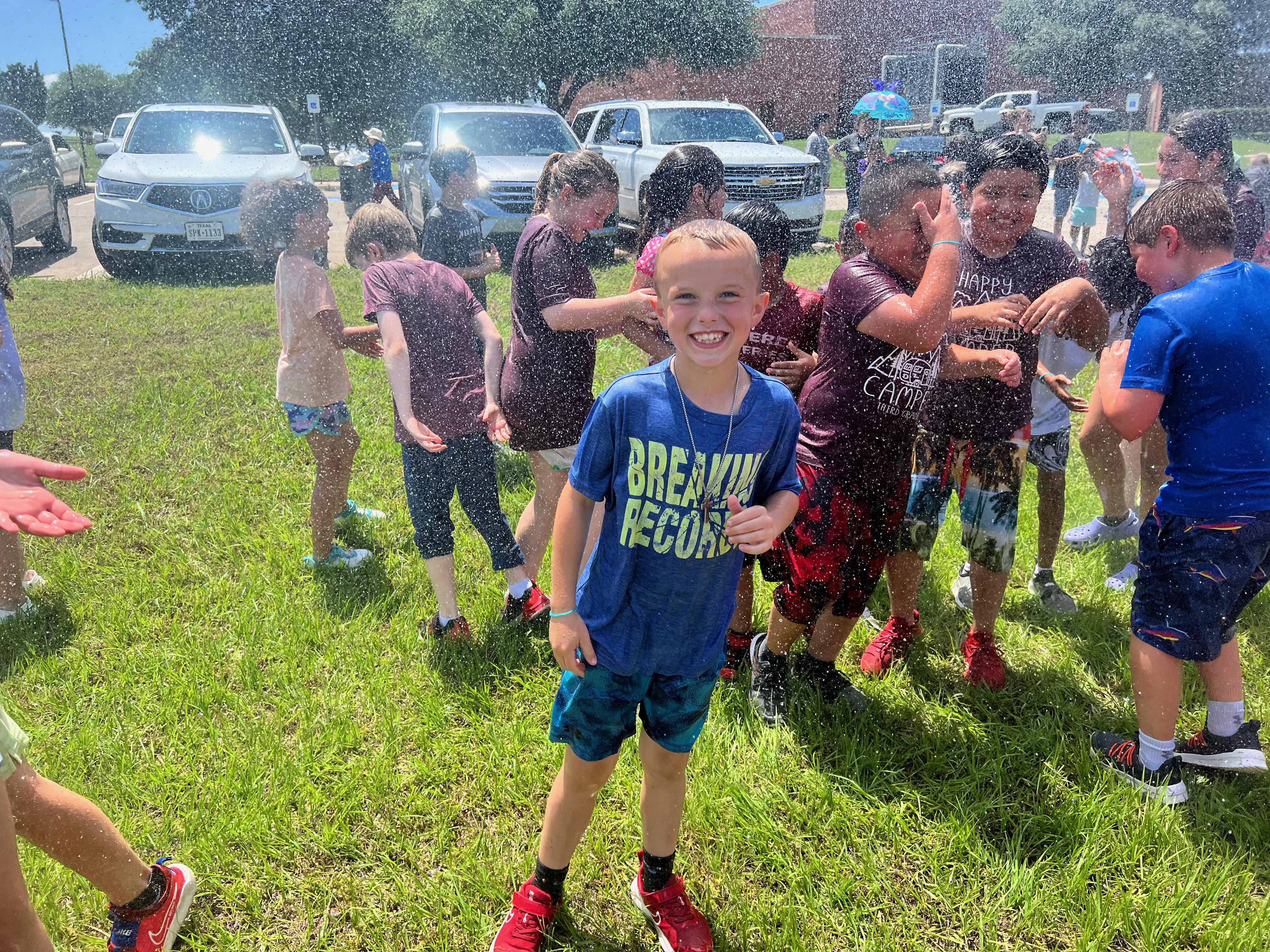 Rann students playing while being sprayed by the Decatur Fire Department.