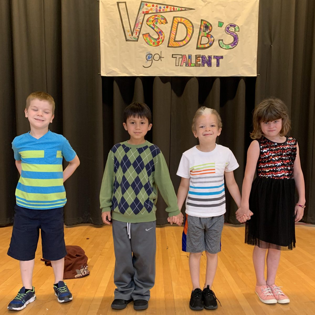 VSDB's Got Talent, 4 preschool students standing on stage with a handmade sign behind them