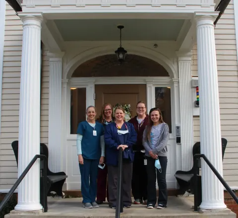 Nursing staff standing in the porch entrance to the Bradford Hall building