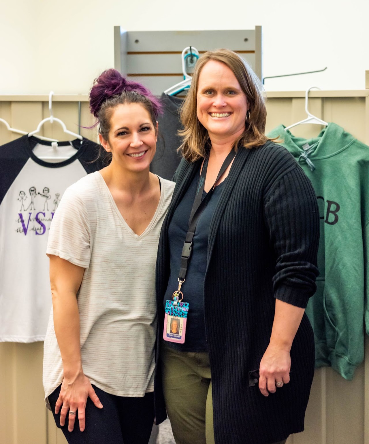 two female staff stand together in the school store 