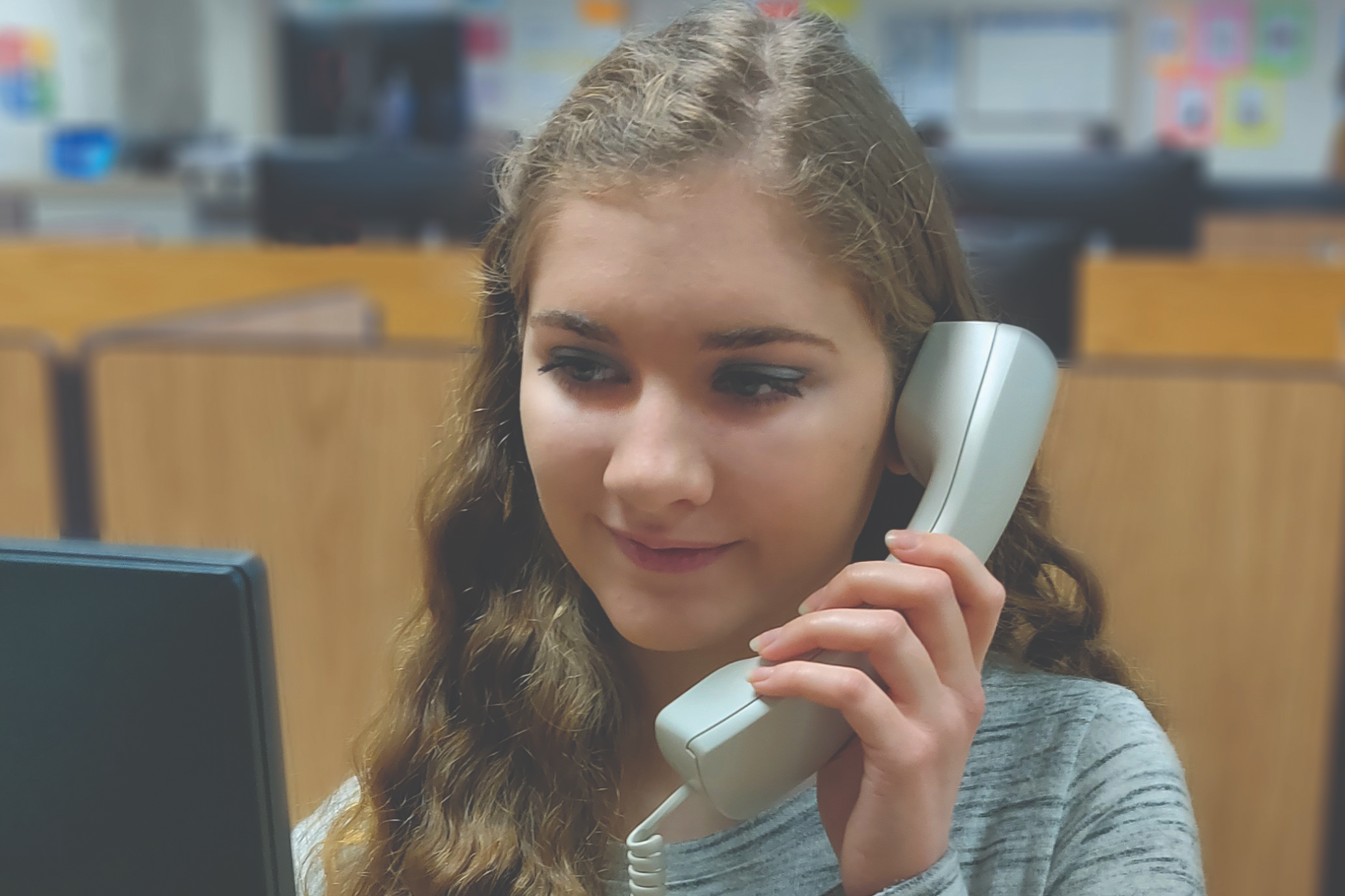 UPCLOSE OF STUDENT ON PHONE