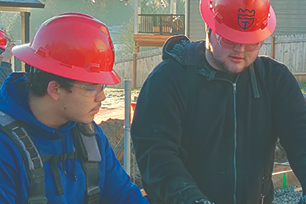 Up close of students looking at building plans