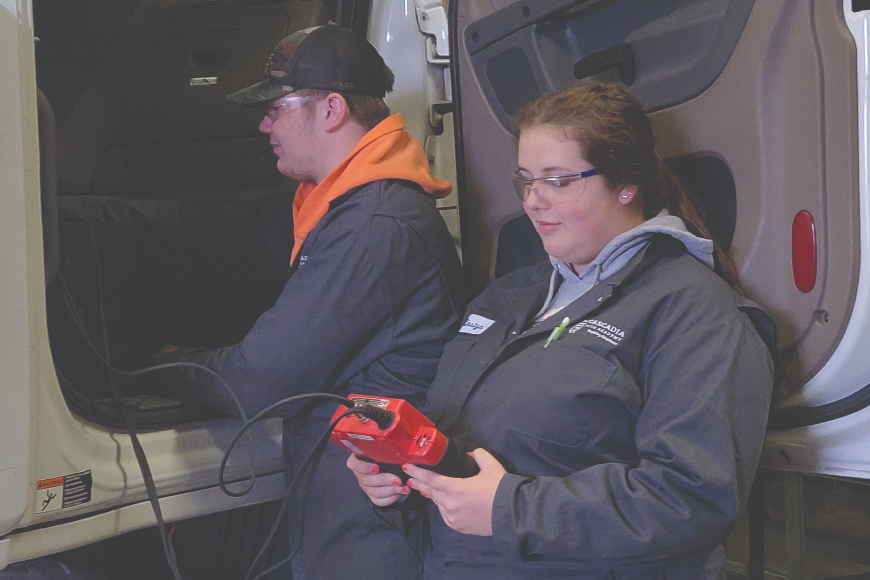 2 STUDENTS WORKING ON A SEMI