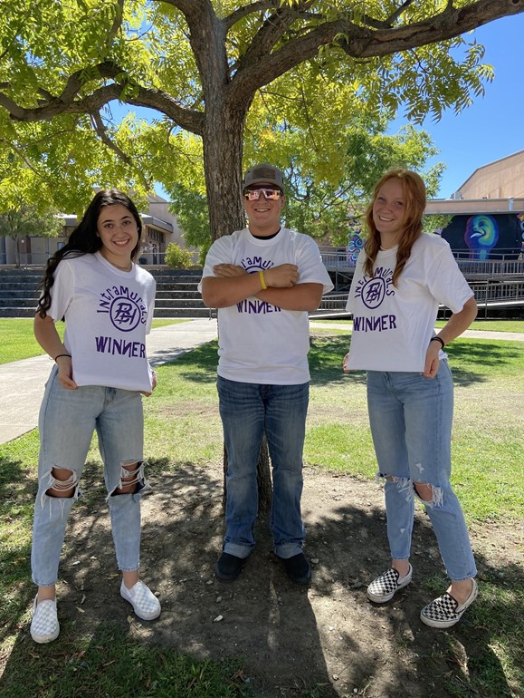 3 students with tshirts that say winner