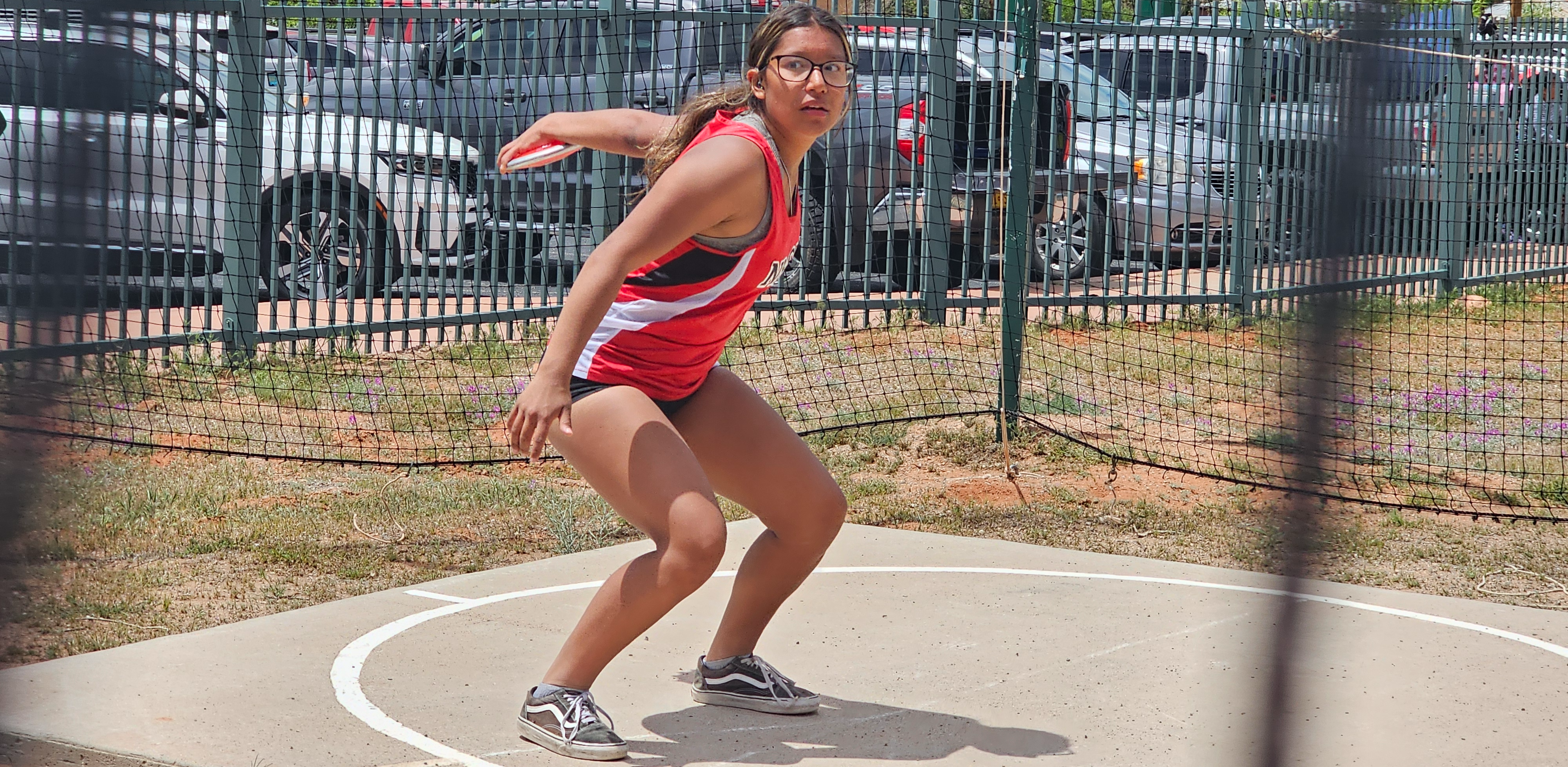 Student with shot put ball during a track meet