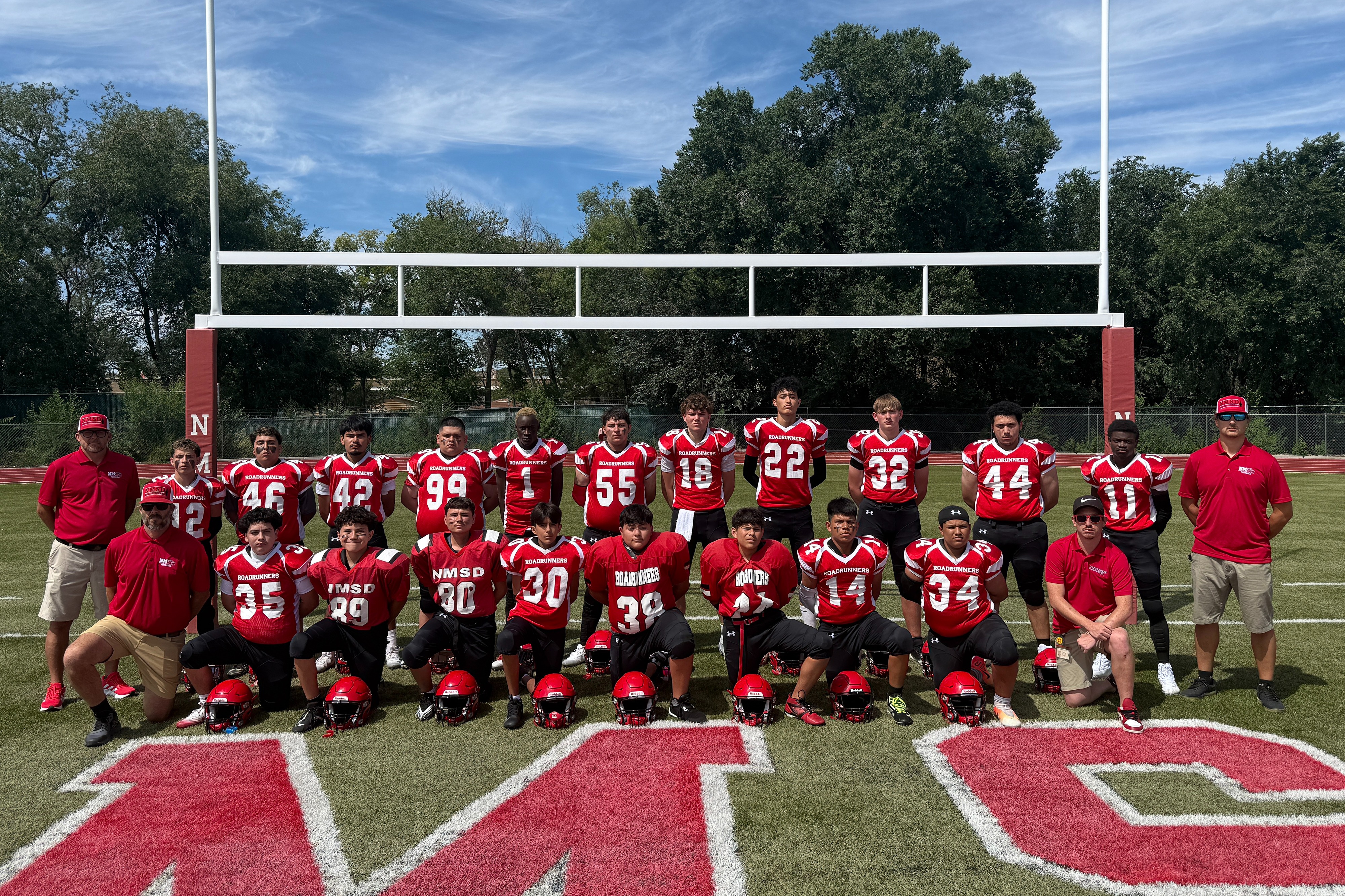 2025-2026 Varsity Football Team with coaches