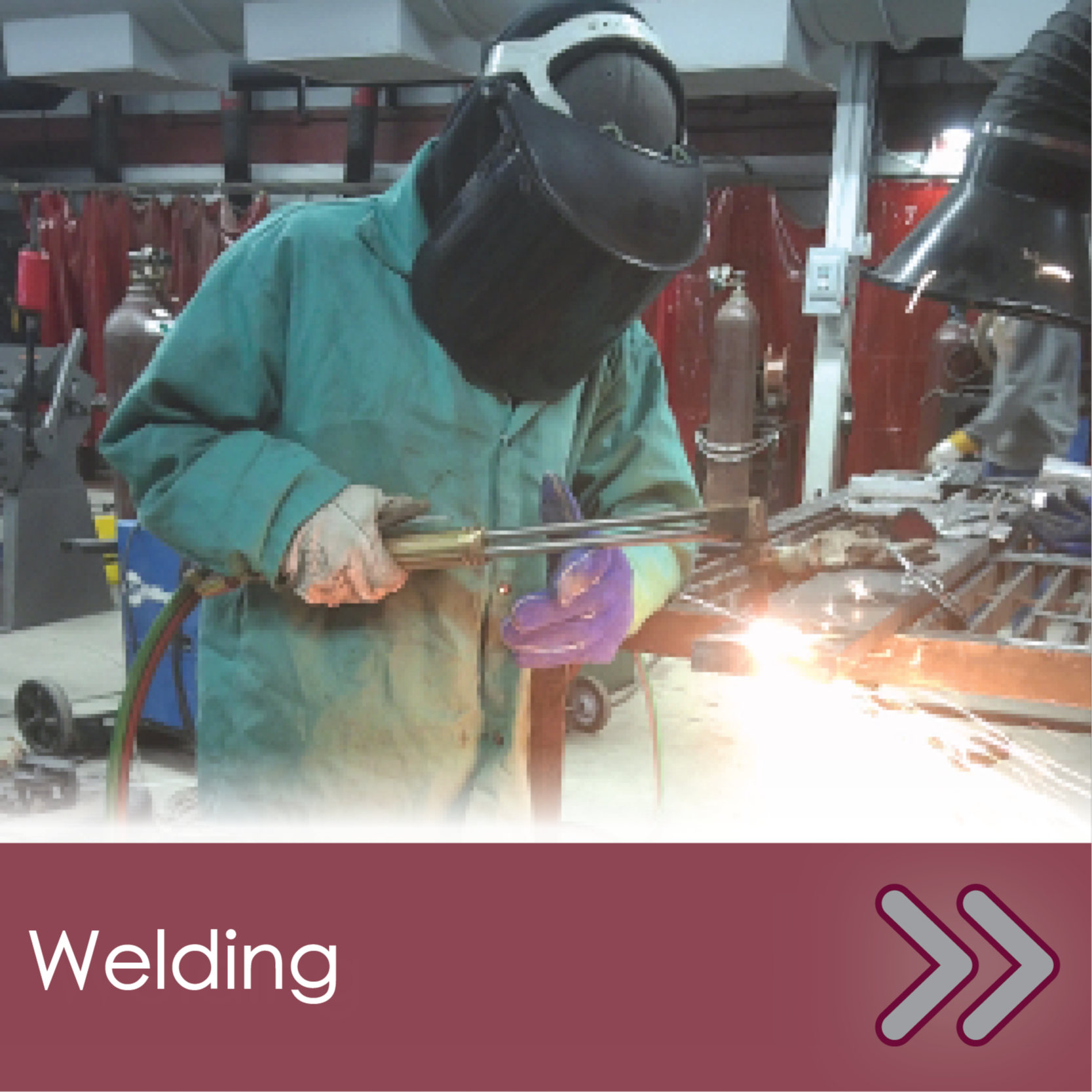 Student in hood using welding torches