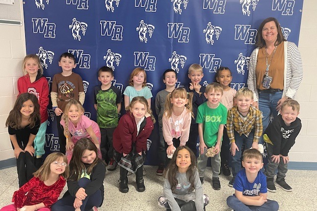 Mrs. Solomon posing with a group of Kindergarteners.