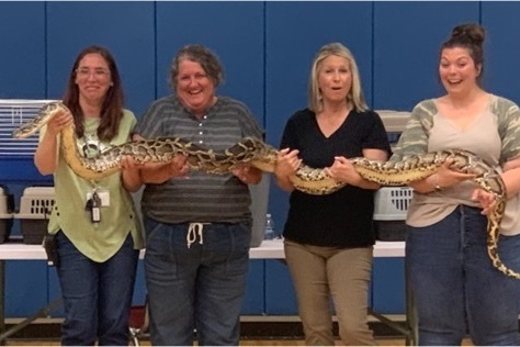 Teachers hold a snake