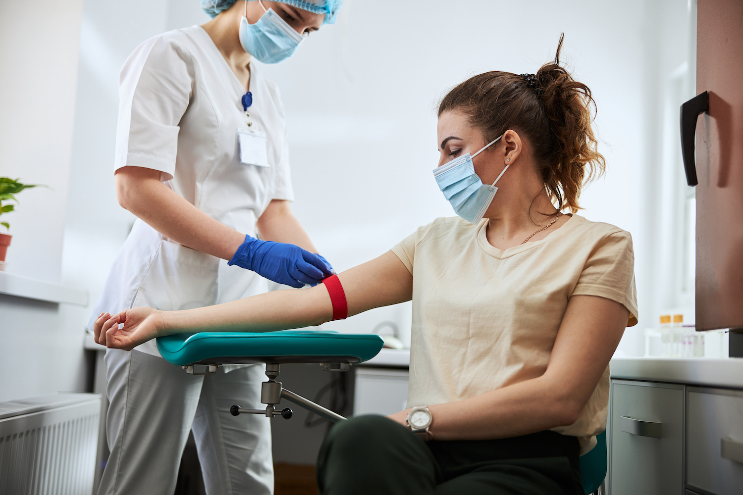 Nurse preparing to draw blood from patient arm