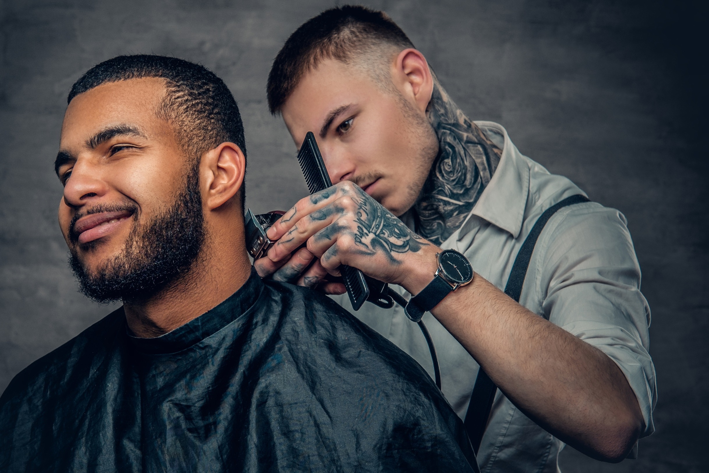 Man cutting another man's hair.