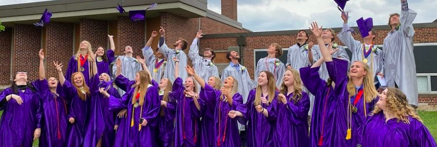 a group of students graduating and throwing their caps